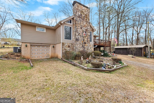 82 Swan Ave, Newnan, GA 30263 - view of home's exterior with a garage, dirt driveway, a chimney, a lawn, and a deck
