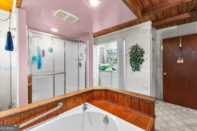 82 Swan Ave, Newnan, GA 30263 - bathroom featuring a shower stall, a garden tub, and washer / dryer
