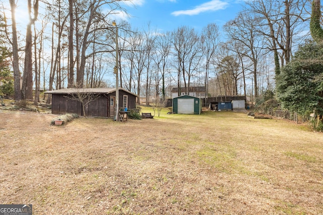 82 Swan Ave, Newnan, GA 30263 - view of green lawn with a storage shed and an outbuilding