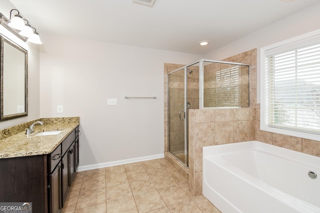 full bathroom featuring a stall shower, baseboards, tile patterned floors, a garden tub, and vanity