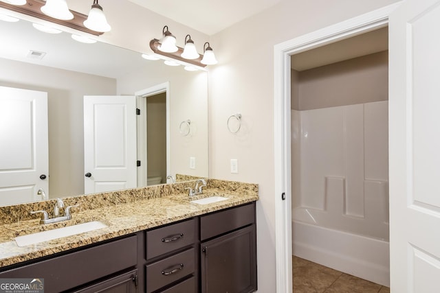 bathroom featuring double vanity, tile patterned flooring, a sink, and visible vents