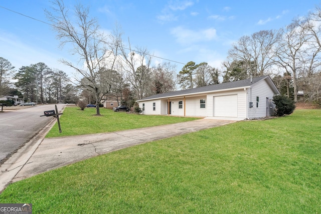 ranch-style house featuring a garage, a front yard, and driveway