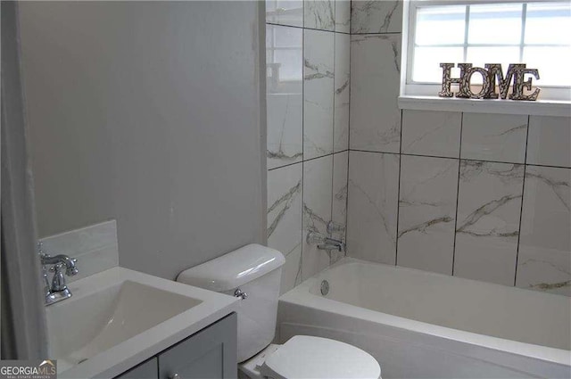 full bathroom featuring bathtub / shower combination, vanity, and toilet