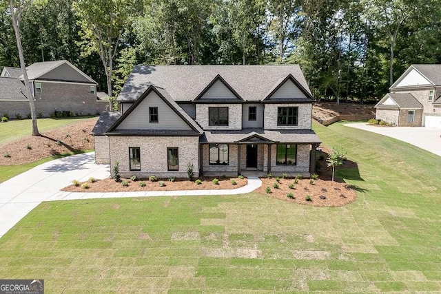 view of front facade featuring brick siding, roof with shingles, covered porch, and a front yard