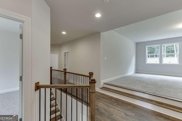 interior space with baseboards, wood finished floors, and recessed lighting