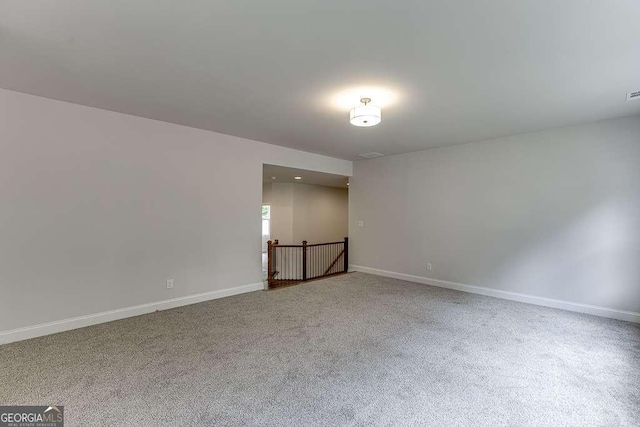 carpeted spare room with baseboards