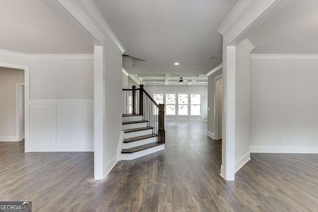 stairway with ornamental molding, visible vents, baseboards, and wood finished floors