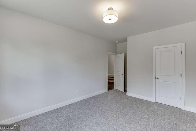 unfurnished bedroom with carpet flooring and baseboards