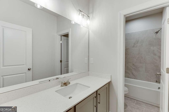 full bath with tile patterned flooring, tub / shower combination, vanity, and toilet