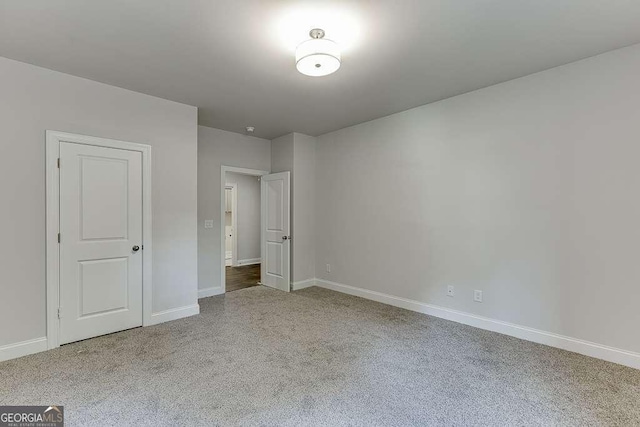 unfurnished bedroom with carpet flooring and baseboards