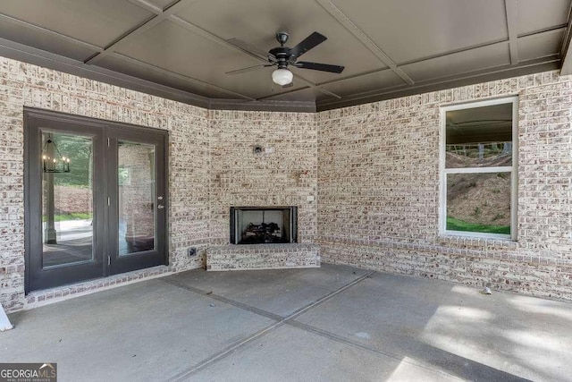 view of patio / terrace featuring an outdoor brick fireplace and ceiling fan