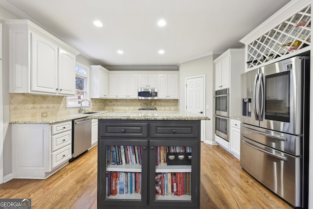 kitchen featuring a sink, stainless steel appliances, and white cabinets