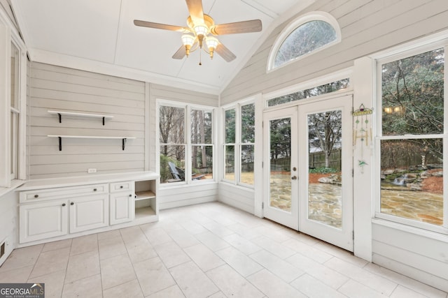 unfurnished sunroom featuring french doors, a ceiling fan, and vaulted ceiling