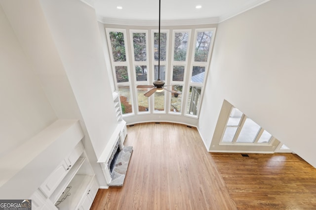 unfurnished living room featuring recessed lighting, visible vents, wood finished floors, and crown molding