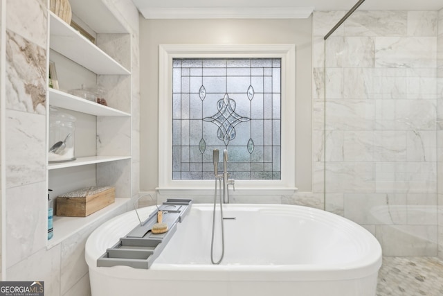 bathroom featuring crown molding and a freestanding tub