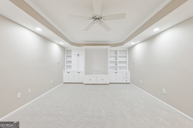 spare room with light carpet, built in shelves, recessed lighting, baseboards, and ceiling fan