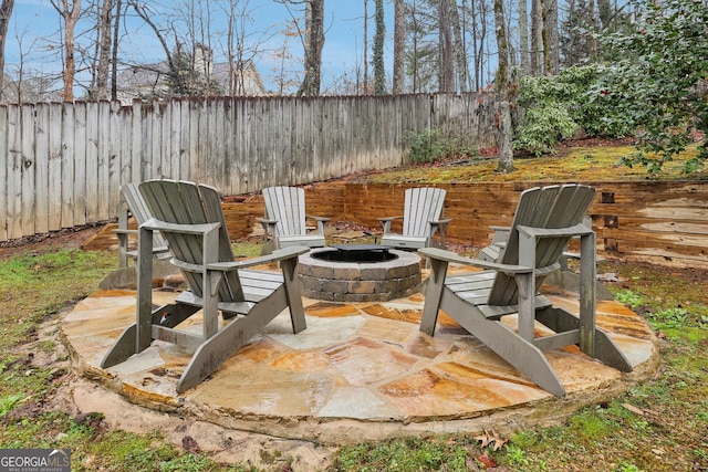 view of patio with a fenced backyard and an outdoor fire pit