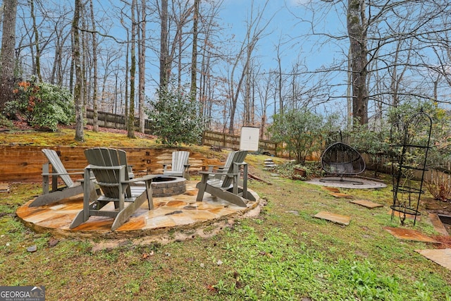 view of yard with a patio, a fenced backyard, and an outdoor fire pit