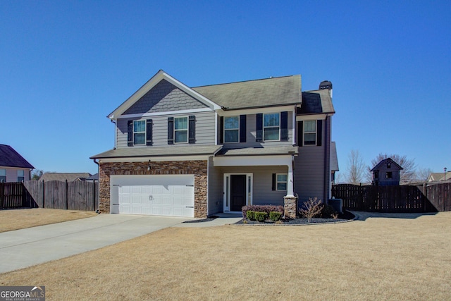 view of front of home featuring driveway, a garage, stone siding, fence, and a front lawn