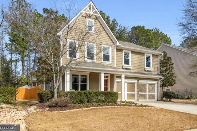 view of front of house with a garage, driveway, and fence