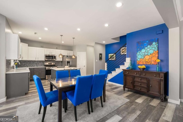 dining space with baseboards, dark wood-style flooring, stairway, and recessed lighting