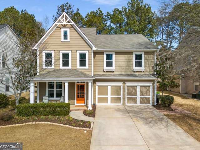 view of front facade with driveway, covered porch, and a garage