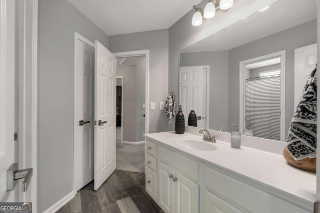 full bathroom featuring vanity and wood finished floors