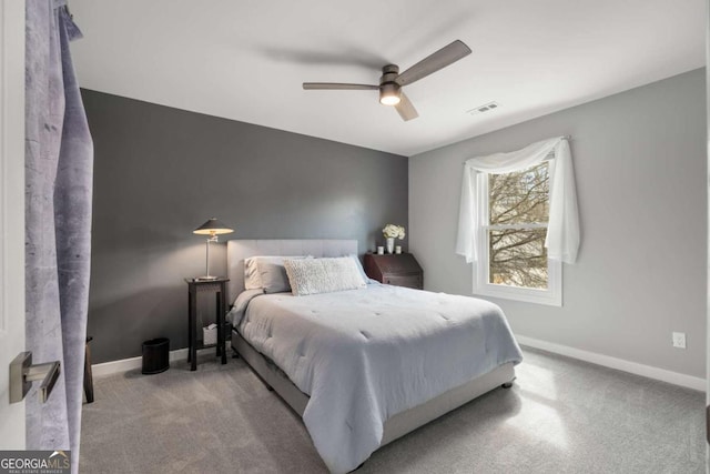 bedroom featuring light carpet, a ceiling fan, visible vents, and baseboards