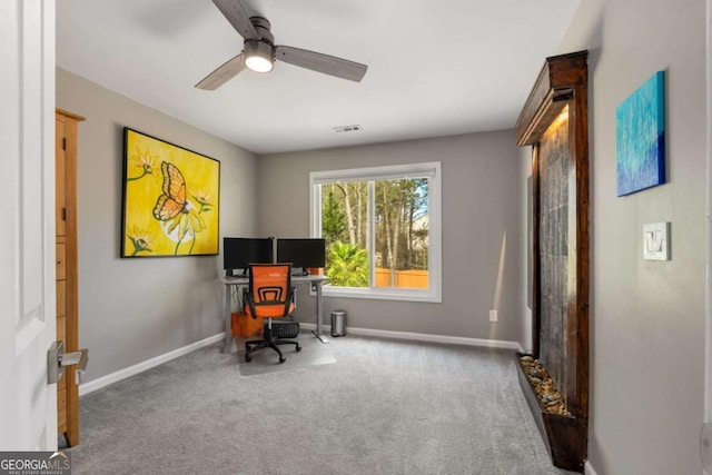 office featuring carpet, visible vents, ceiling fan, and baseboards