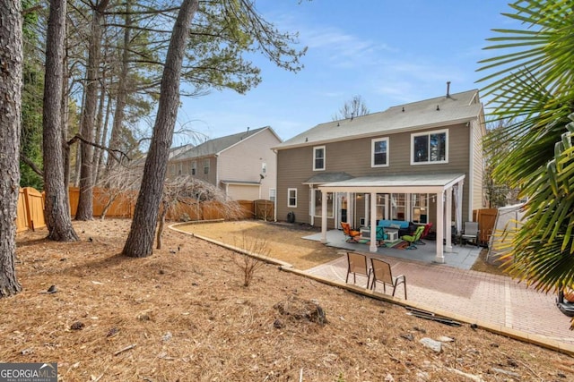 rear view of house with a patio area and a fenced backyard