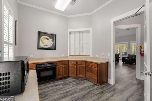 kitchen with visible vents, black oven, light countertops, brown cabinets, and dark wood-style floors