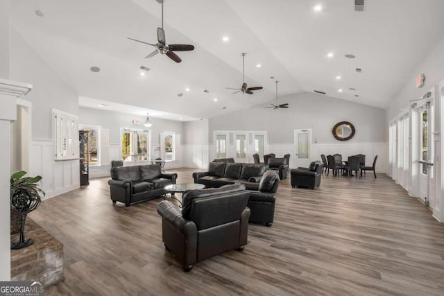 living room with a wainscoted wall and a healthy amount of sunlight