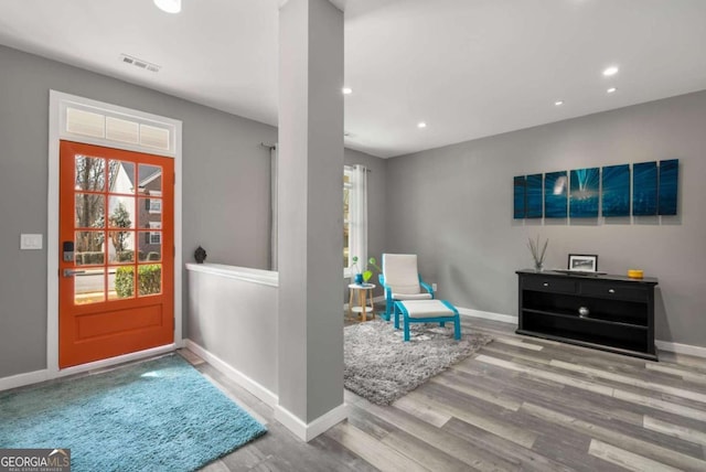 foyer entrance with light wood-style flooring, visible vents, baseboards, and recessed lighting