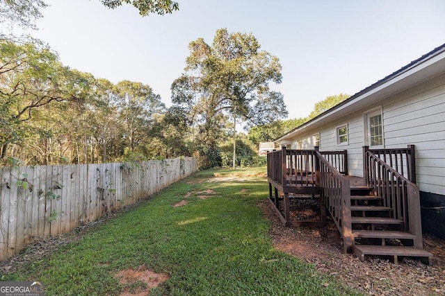 view of yard featuring stairs, fence, and a wooden deck