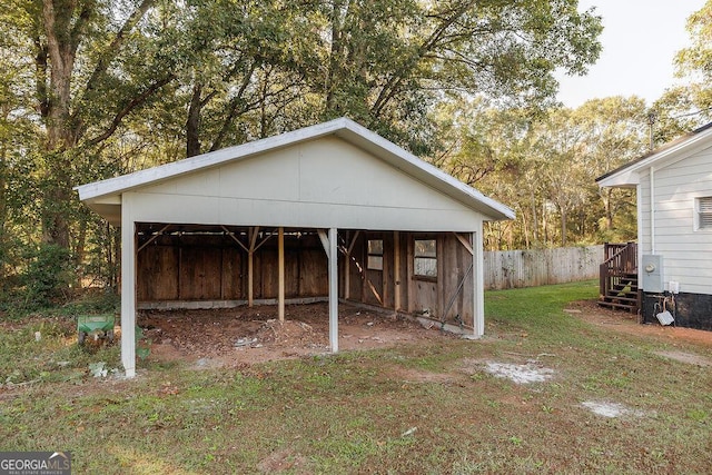 view of pole building with a yard and fence