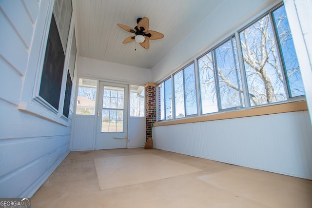 unfurnished sunroom featuring a ceiling fan and wooden ceiling