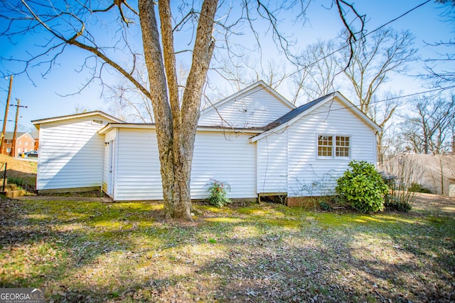 back of property with a lawn