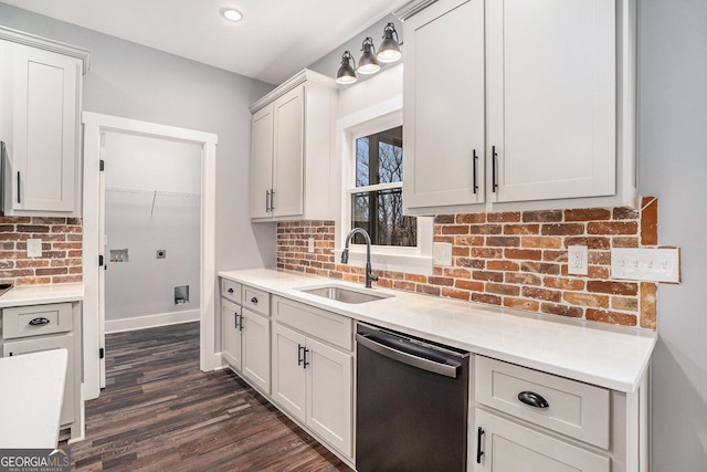 kitchen with dishwashing machine, a sink, white cabinets, light countertops, and backsplash