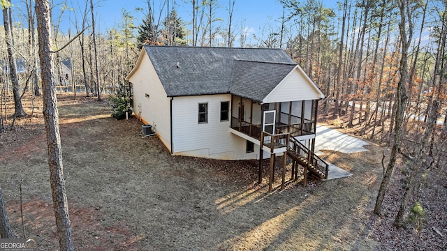 view of front of property with stairs, a shingled roof, cooling unit, and a sunroom