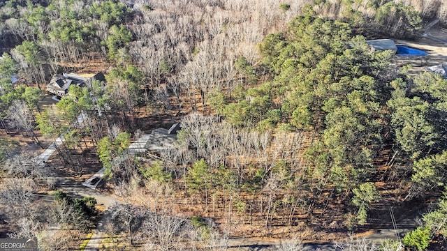 birds eye view of property with a wooded view