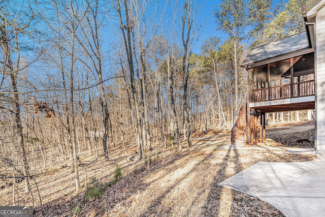 view of yard with a sunroom and stairway