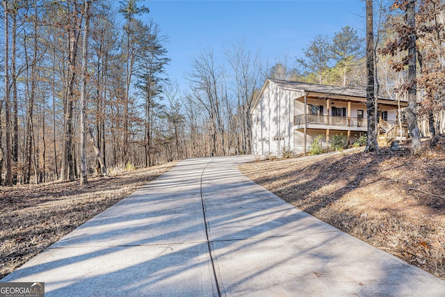 view of side of property featuring covered porch