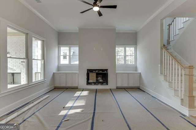 unfurnished living room with a healthy amount of sunlight, a fireplace, and stairs