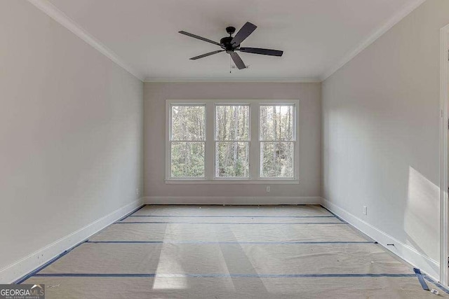 unfurnished room featuring a ceiling fan, crown molding, and baseboards