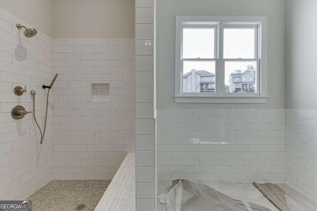 full bath with a tile shower