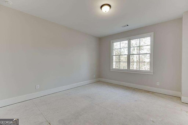 spare room with visible vents and baseboards