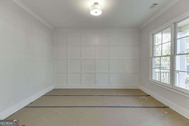 empty room with ornamental molding, visible vents, and baseboards