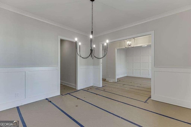 unfurnished dining area with ornamental molding and a wainscoted wall