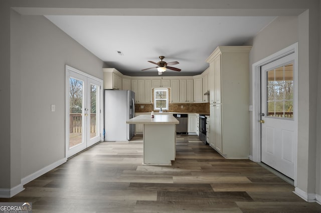 2820 Maxwell Pl, Lithia Springs, GA 30122 - kitchen with wood finished floors, electric range oven, decorative backsplash, stainless steel dishwasher, and fridge with ice dispenser