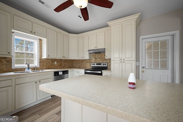 2820 Maxwell Pl, Lithia Springs, GA 30122 - kitchen with visible vents, ceiling fan, under cabinet range hood, stainless steel appliances, and a sink